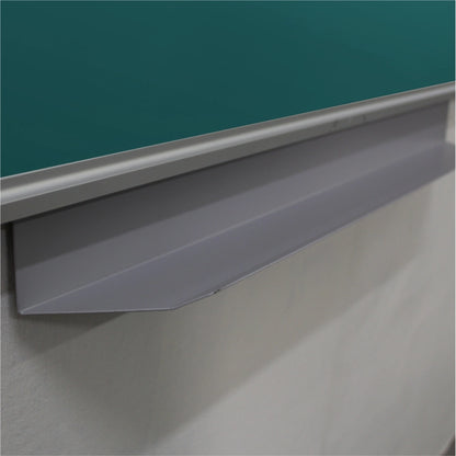 Close-up of a gray metal chalkboard lip or penrail mounted beneath a green chalkboard on a white wall.